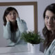 young pretty smiling woman hiding her negative emotions