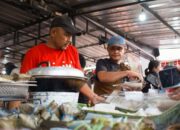 Vibrant street vendors in Jakarta preparing traditional snacks at a busy market.